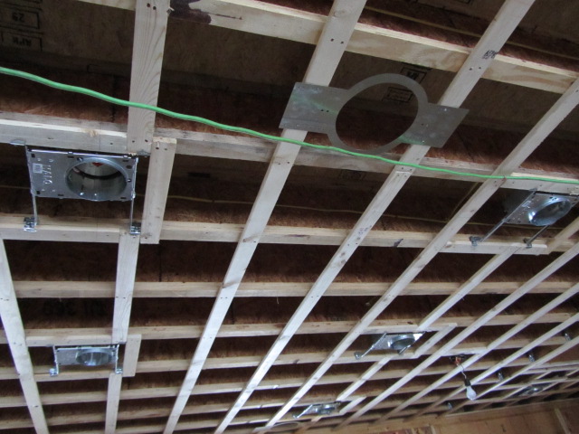 Carefully laid out recessed lighting wiring above a ceiling